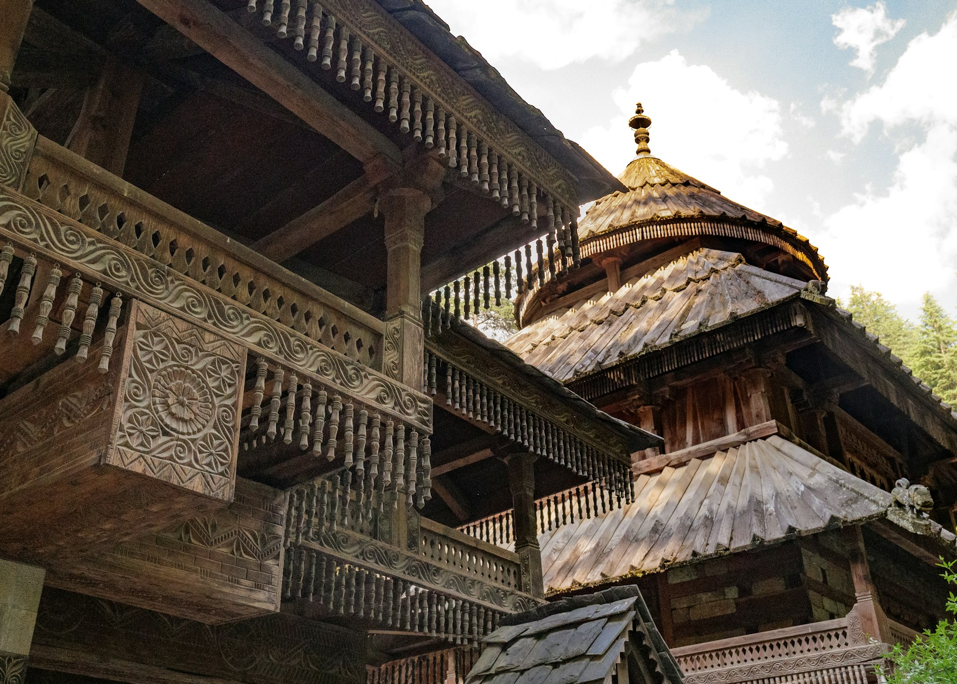 a large wooden building with a clock on it's side
