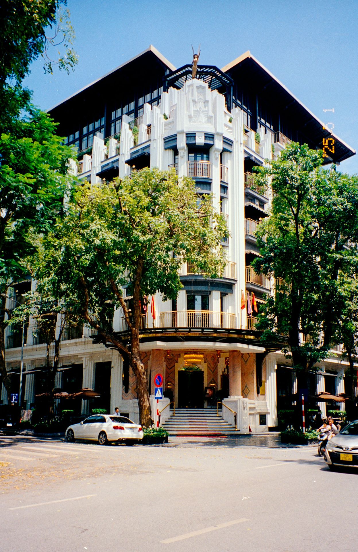 A large, elegant building stands on a street.